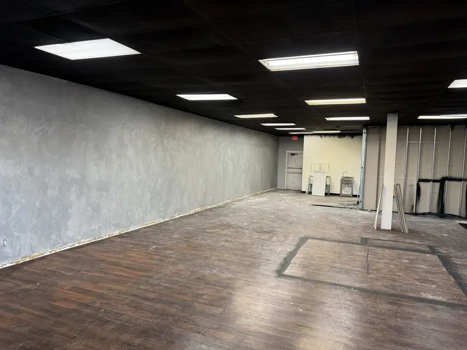 Before: empty commercial space with worn floor