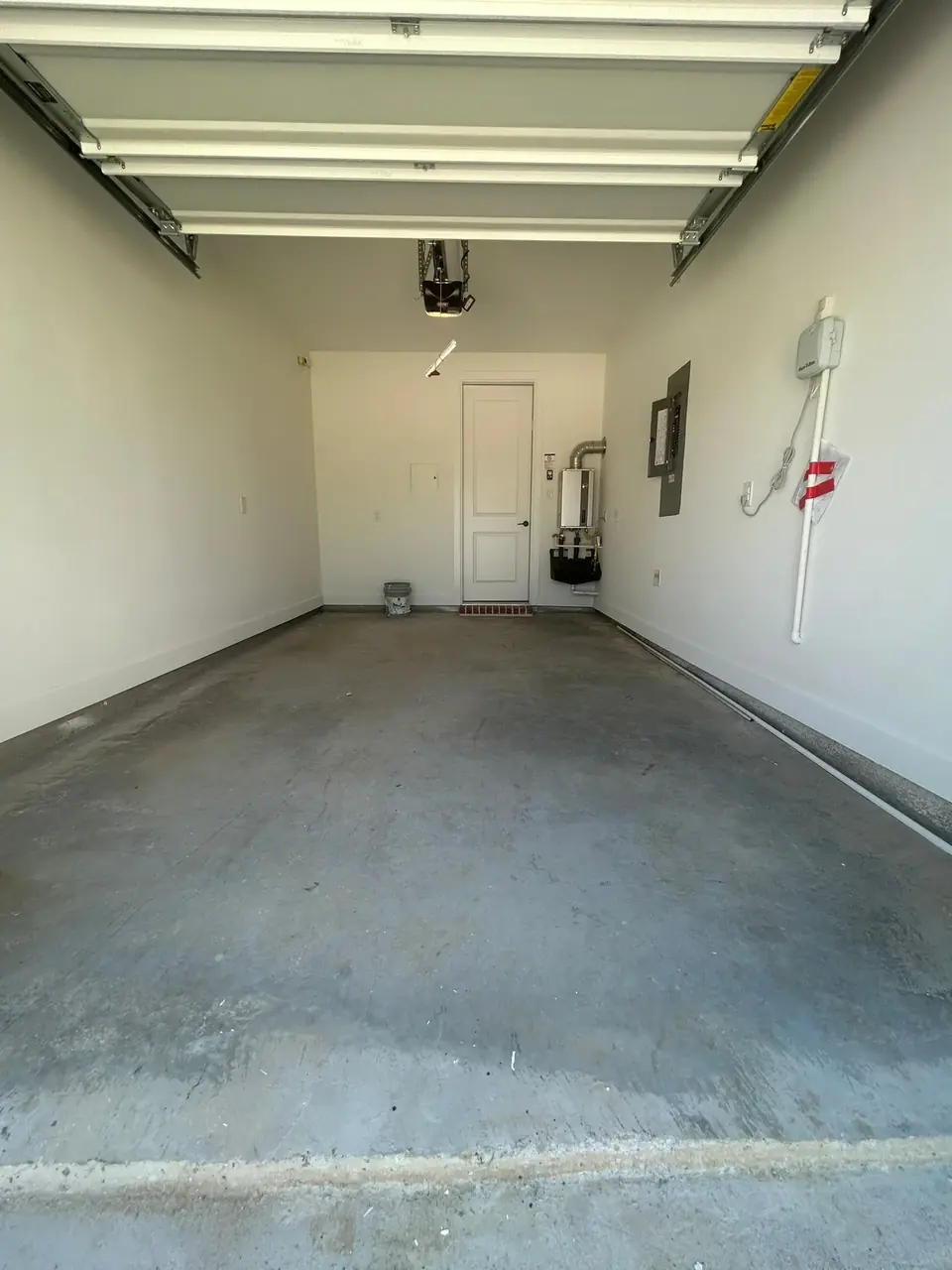 Before: empty garage bay with concrete floor