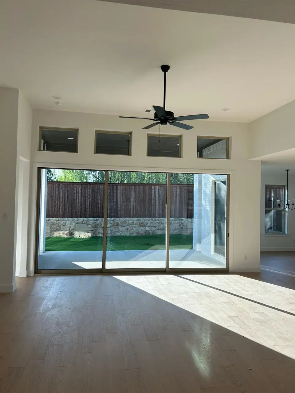 Before: empty living room with sliding doors